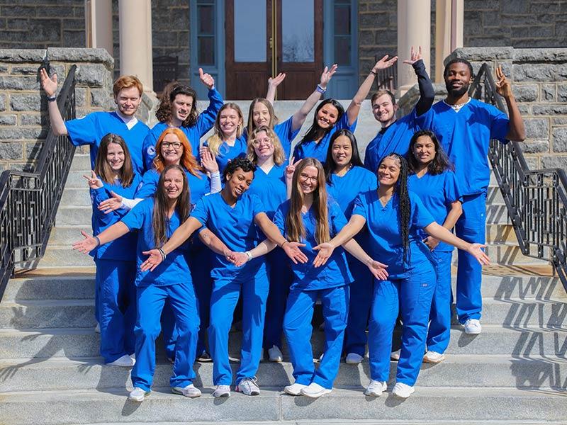 Group of nursing students wearing blue scrubs